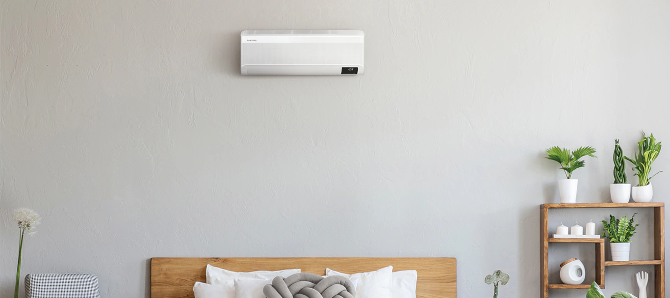 Discreet wall-mounted air conditioner in a calm bedroom